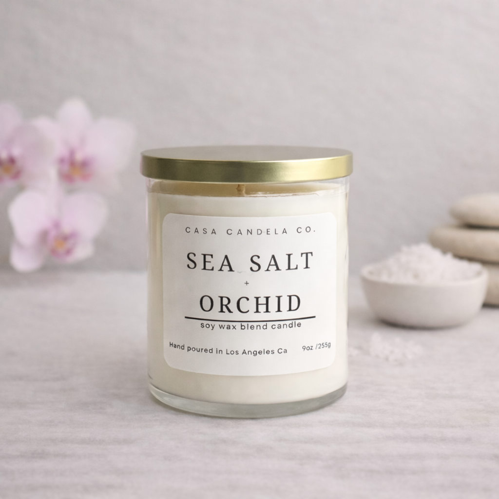 Sea Salt Orchid soy wax blend candle by Casa Candela Co. in a glass jar with gold lid, hand-poured in Los Angeles.